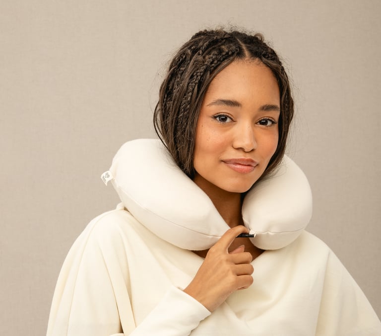 girl using home of wool neck pillow for travel
