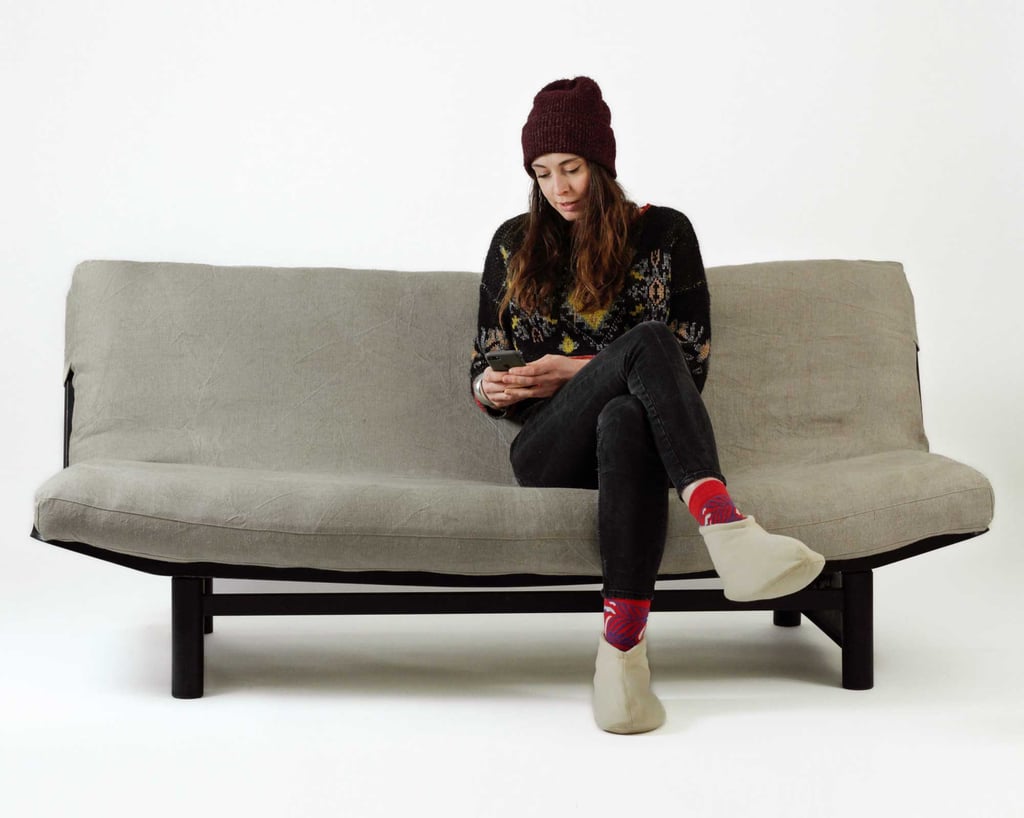 wool futon mattress on a sofa with a woman sitting on it