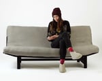 wool futon mattress on a sofa with a woman sitting on it
