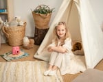 girl sitting in home of wool organic teepee tent