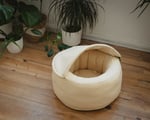 cat cave bed from wool in a room with plants