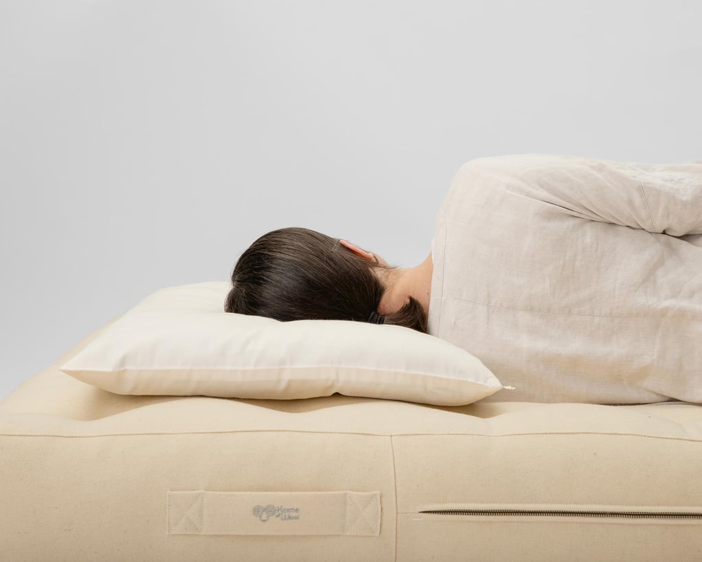 wool thin pillow with a woman sleeping on it, showing her back and spine position