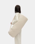 wool carry bag for wool pilates mat being carried on a persons back