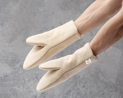 Wool oven mitts worn by someone
