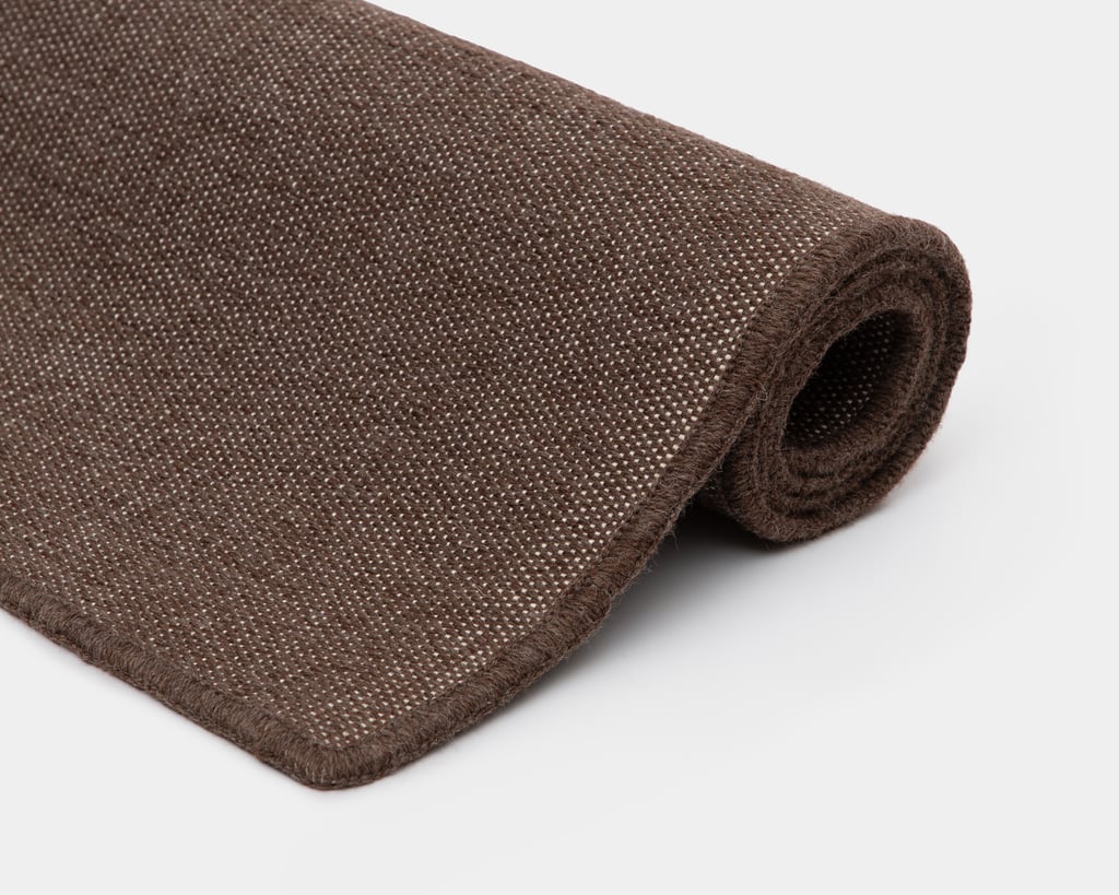 rolled up wool flat woven rug